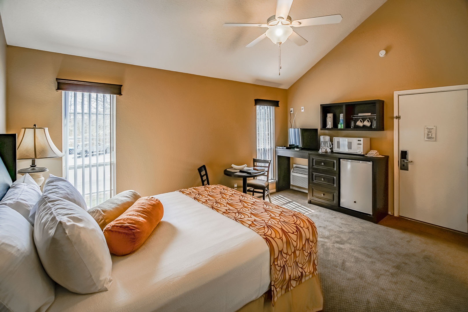 A bedroom with partial kitchen at The Townhouses Resort in Branson, Missouri.